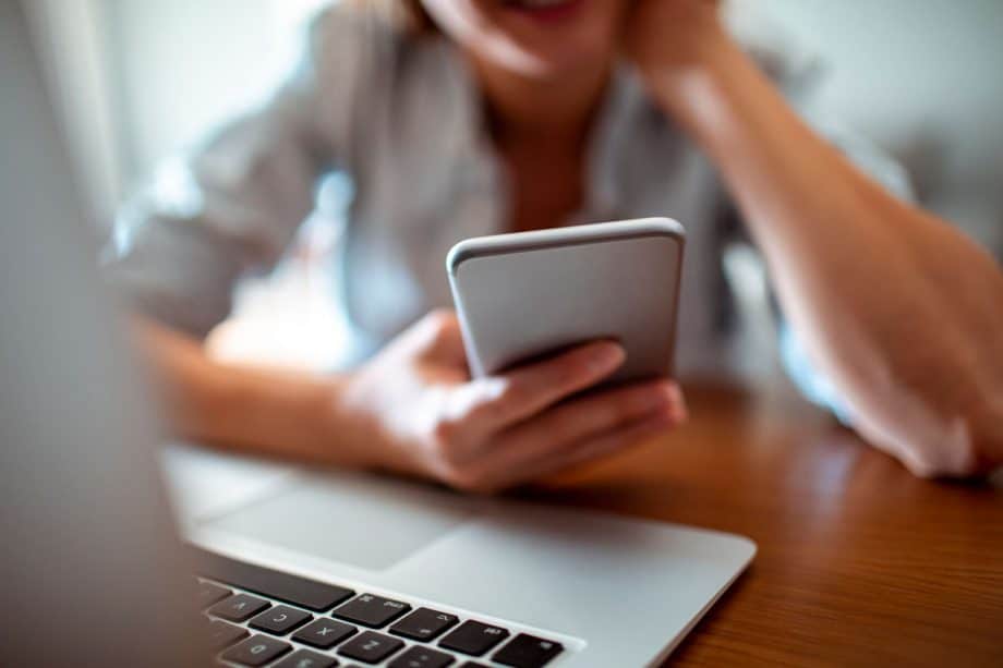 person using computer and phone